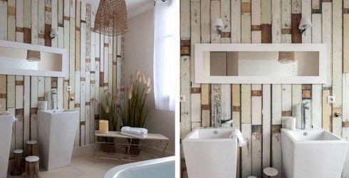 Baño decorado con paredes de papel pintado imitando a tablillas desgastadas de madera.